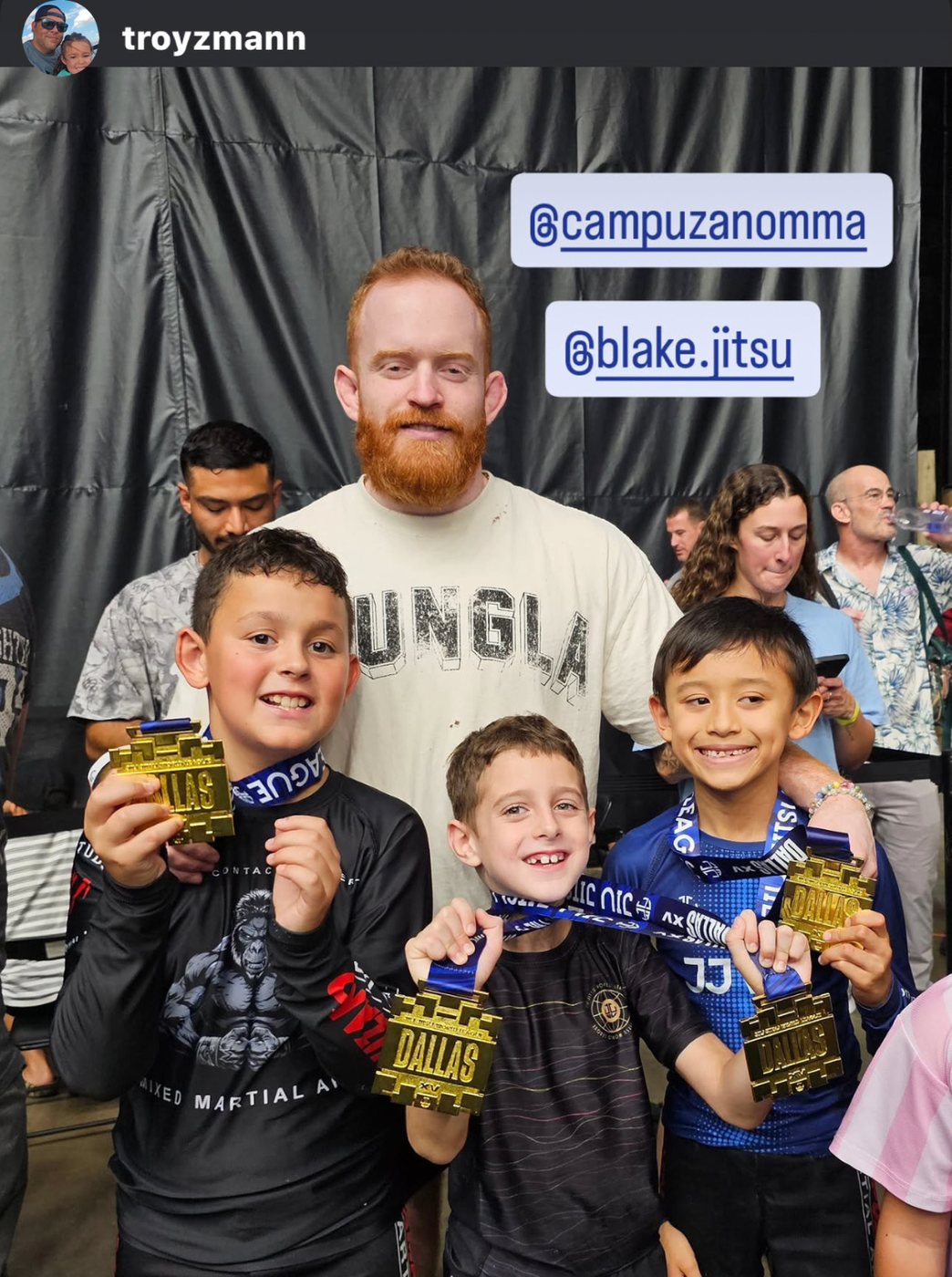Blake Bradshaw with students holding medals